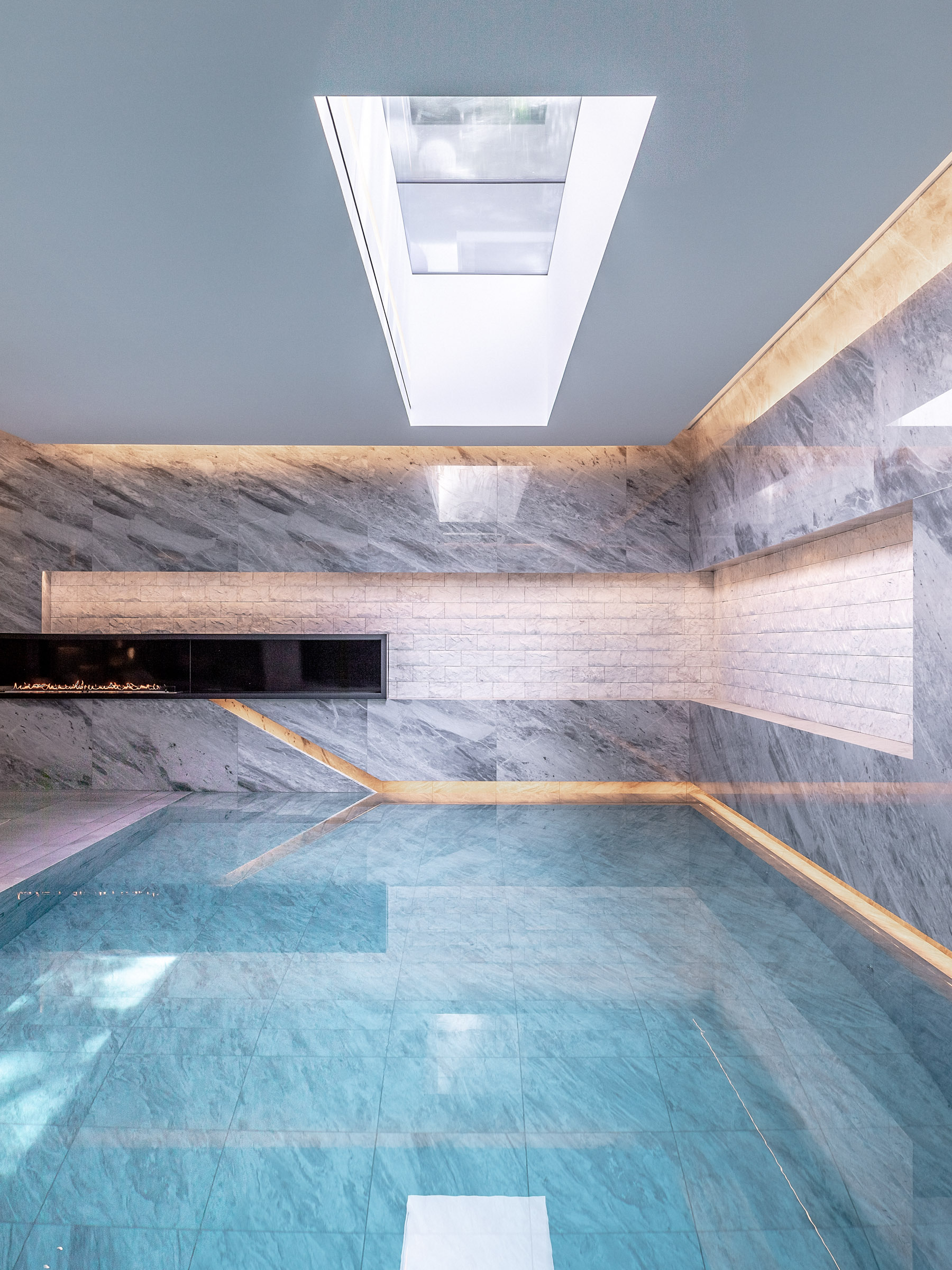 IO House London interior pool area showing LED lighting with skylight reflecting in the water - dpa lighting and Taran Wilkhu
